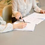 Woman signing non-compete agreement